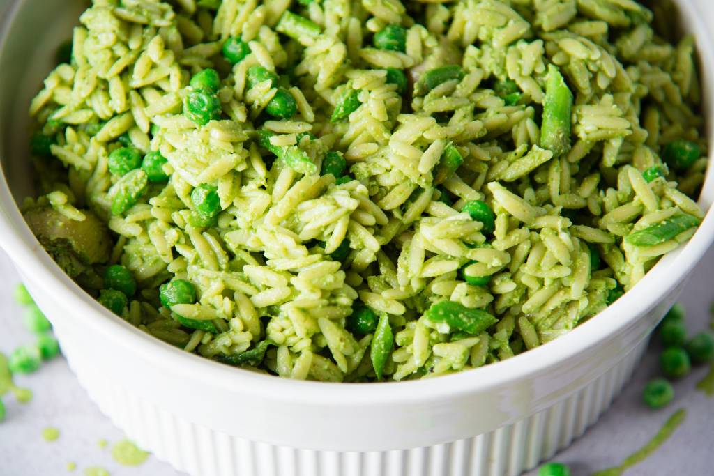 a close-up of a white bowl of orzo pasta salad
