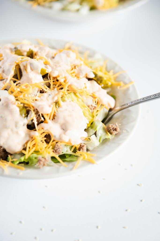 a close up of a salad with a fork in it