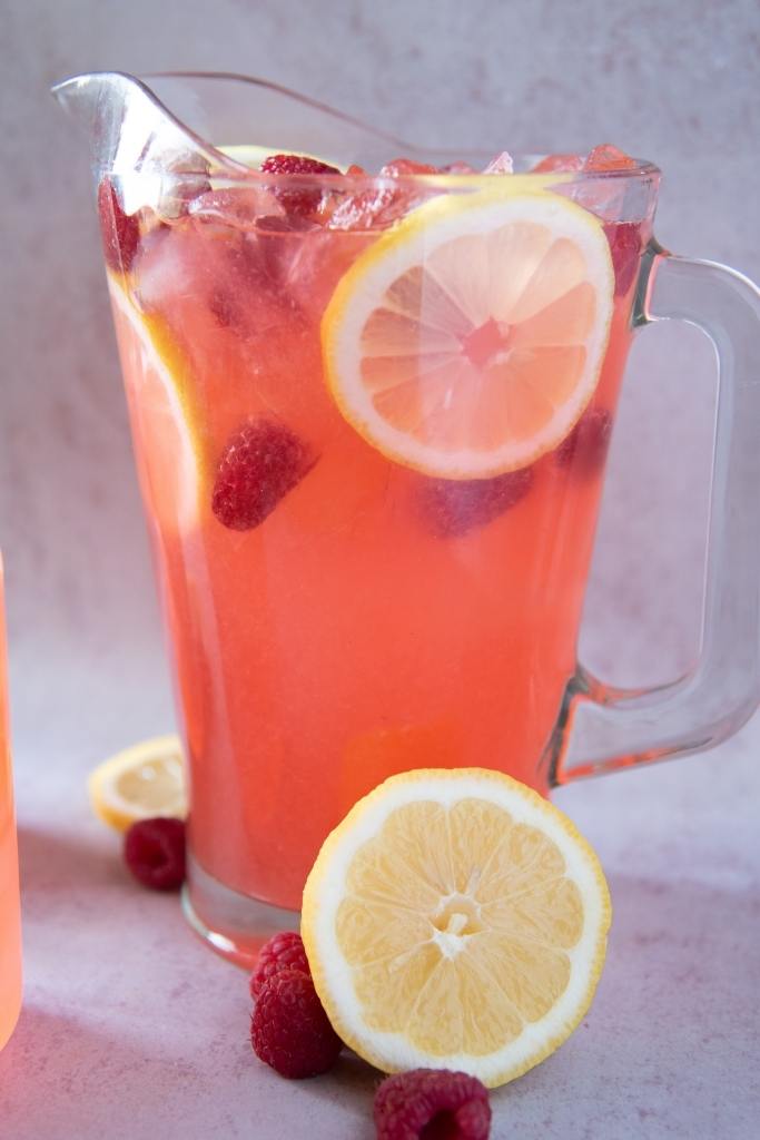 a close up of a pitcher of raspberry lemonade 