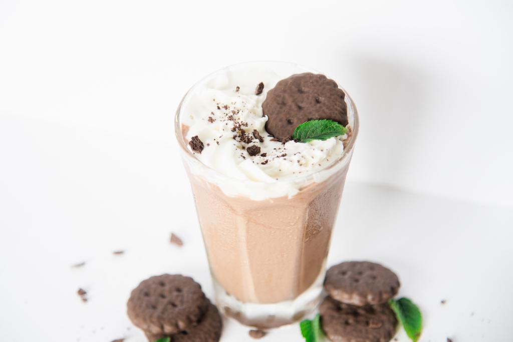 a shake with cookies and mint leaves around it 