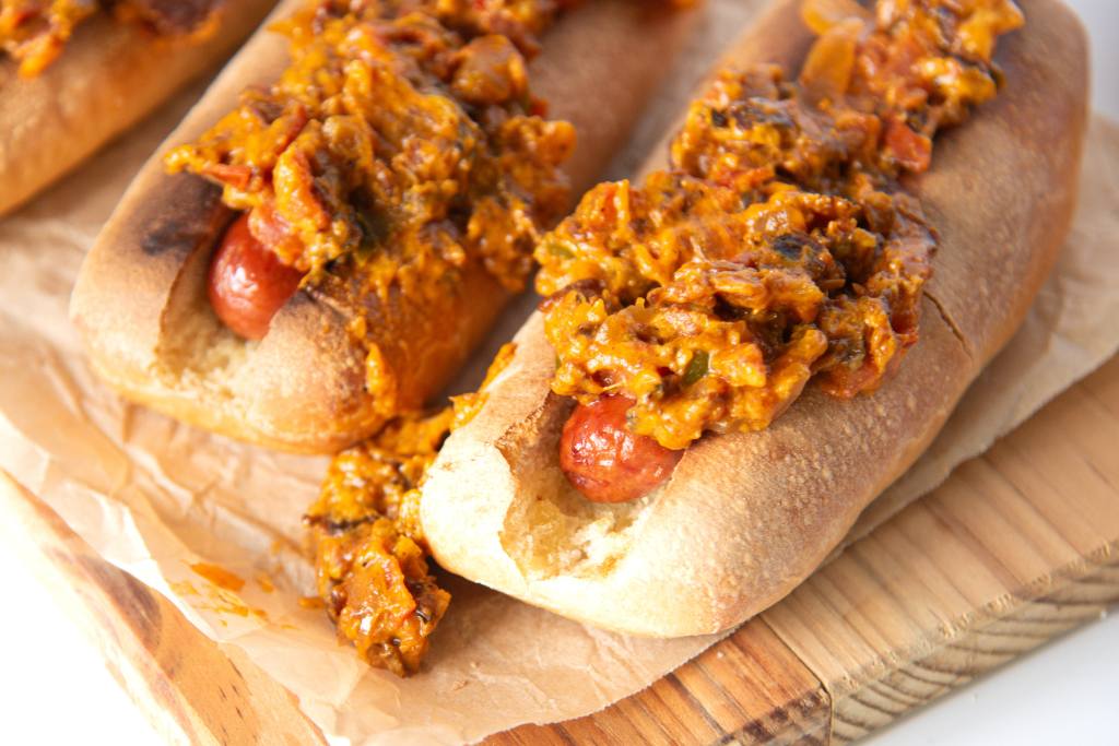 3 hot dogs on a wooden serving tray