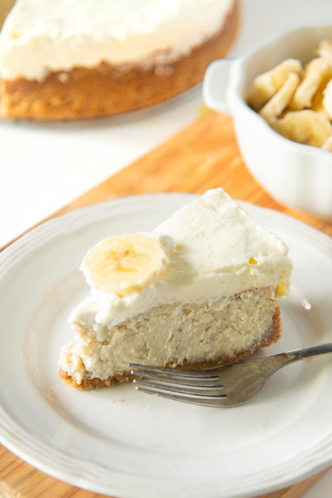 a close up of a slice of cheesecake on a plate, there is also a fork on the plate 