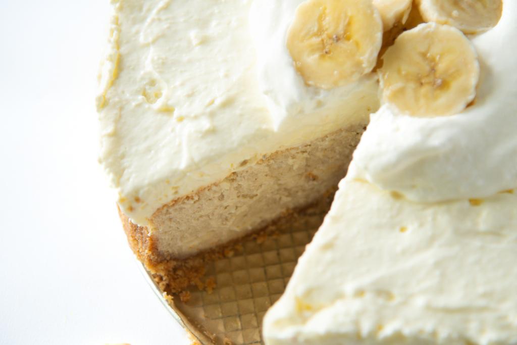 a close up of a banana cheesecake with a slice taken out of it 