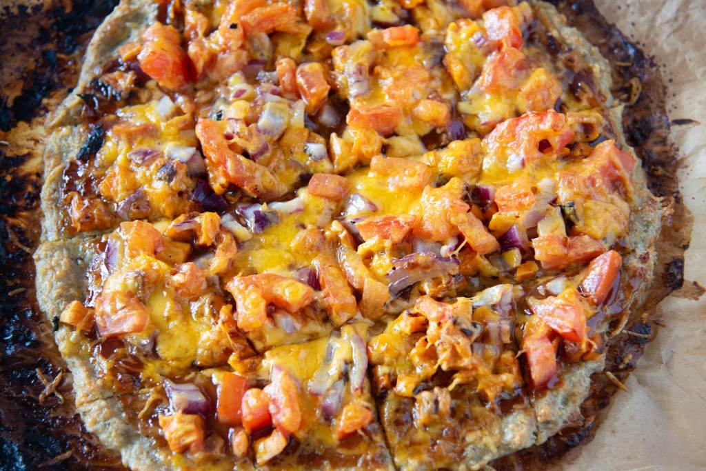 a close up of a slice bqq chicken pizza