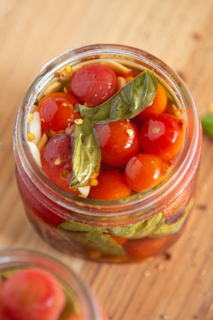 a close up of an open jar of tomatoes 