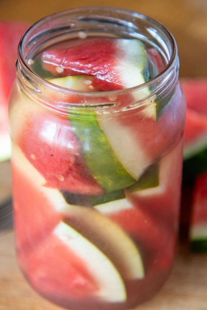 a close up of a jar of pickled watermelon