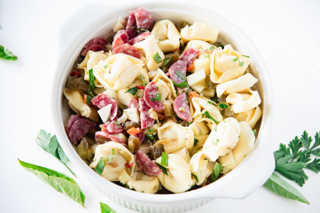 a bowl of mixed pasta salad with no dressing on it 