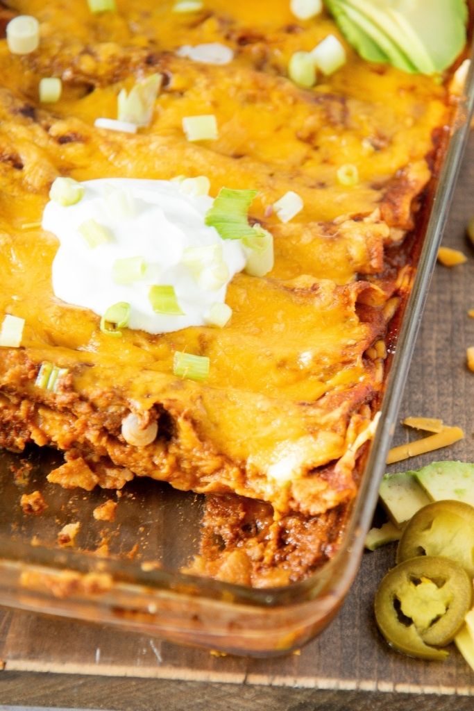 a close up of a pan of enchiladas with taken out of it