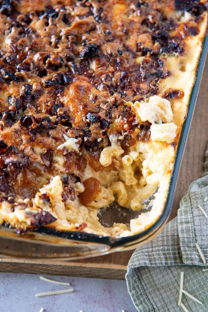 a pan of mac n cheese with a spoonful taken out of it